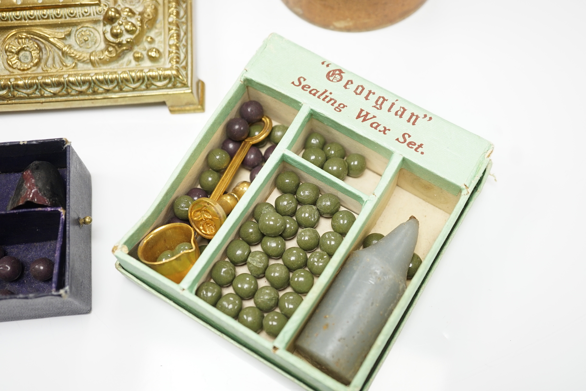 A brass inkwell, a treen box and a sealing wax set